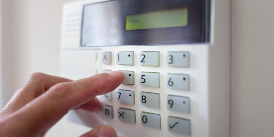 Security alarm keypad with person arming the system concept
