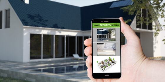 home security system - hand hold a phone with cctv app on a screen